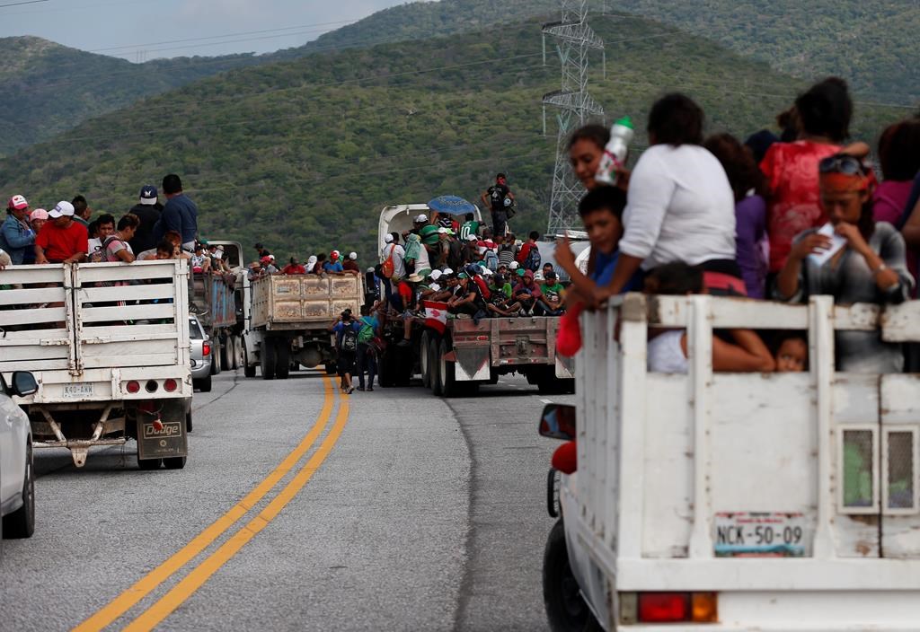Migrants hitch rides in the back of trucks as the thousands-strong caravan of Central Americans hoping to reach the U.S. border moves onward from Juchitan, Oaxaca state, Mexico, Thursday, Nov. 1, 2018.