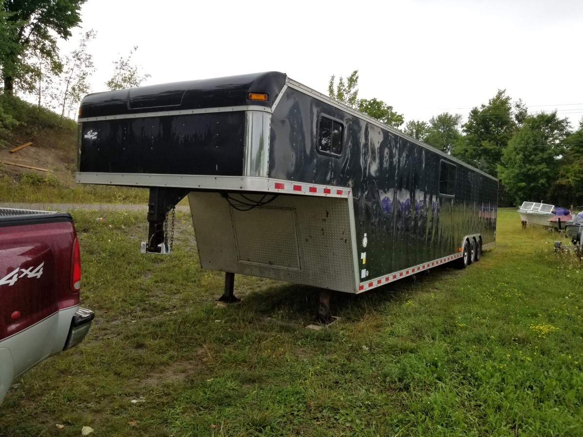 This trailer containing two race cars was stolen.