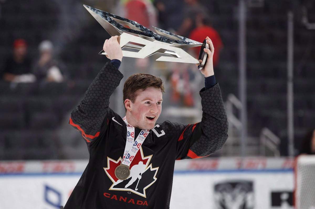 Canada’s Alexis Lafreniere (11) hoists the Hlinka Gretzky Cup following the Hlinka Gretzky Cup gold medal game against Sweden, in Edmonton on Saturday, August 11, 2018. Serge Beausoleil might be the head coach of the Rimouski Oceanic, but even he can feel like the student when forward Alexis Lafreniere hits the ice.