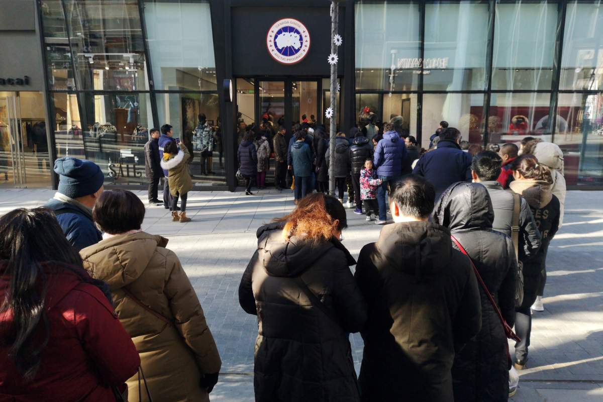 People queue outside the newly opened flagship store of Canadian luxury parka maker Canada Goose, in Sanlitun district of Beijing, China December 30, 2018. 