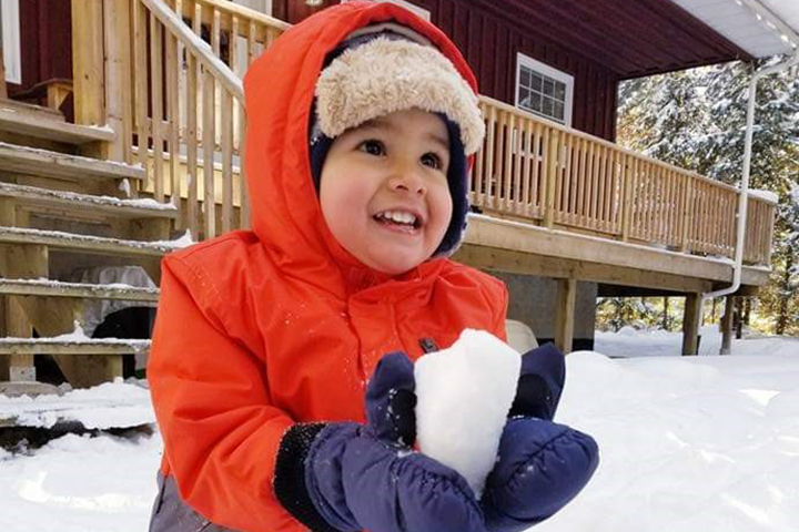 Three-year-old Thomas Montoya playing in the snow.