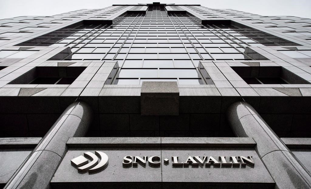 The headquarters of SNC Lavalin is seen Thursday, November 6, 2014 in Montreal. SNC-Lavalin Inc. is eliminating about 100 positions in Canada at the same time as the Quebec engineering firm is being described by political leaders as being vulnerable to a foreign takeover.