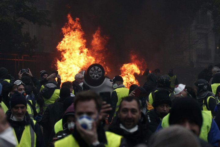 Cars burn as protesters wearing yellow vests (gilets jaunes) clash with riot police near the Arc de Triomphe as part of a demonstration over high fuel prices on the Champs Elysee in Paris, France, 01 December 2018.