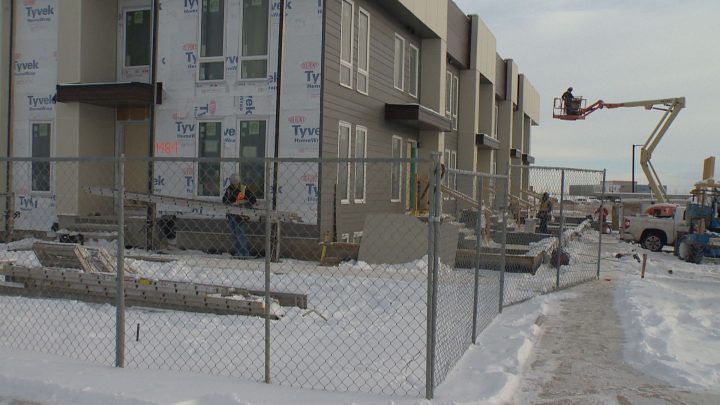 Multi-family housing construction going up in Calgary's SE during Alberta's downturn.