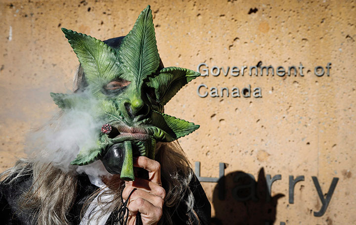 Cannabis supporter Heather Pratt lights up at a rally outside governments offices following the legalization of cannabis in Calgary, Alta., Wednesday, Oct. 17, 2018.