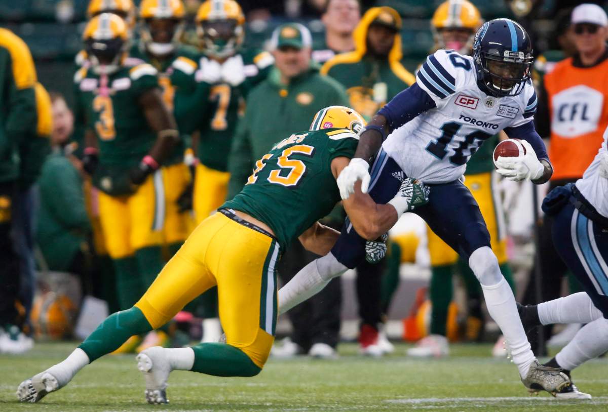 Toronto Argonauts' Armanti Edwards, right, is tackled by Edmonton Eskimos' Korey Jones during first half CFL football action in Edmonton, Saturday, Oct. 14, 2017. 