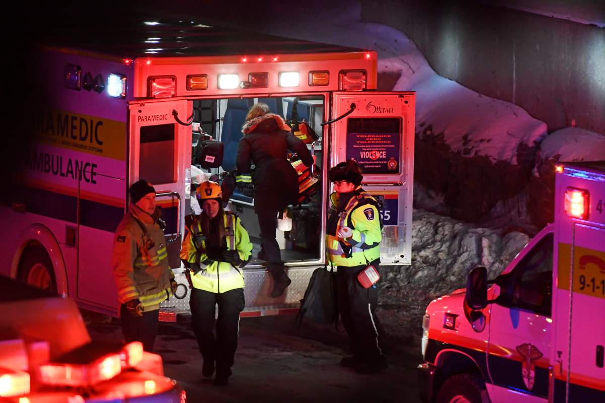 Police and first responders work at the scene where a double-decker city bus struck a transit shelter in Ottawa, on Friday, Jan. 11, 2019.