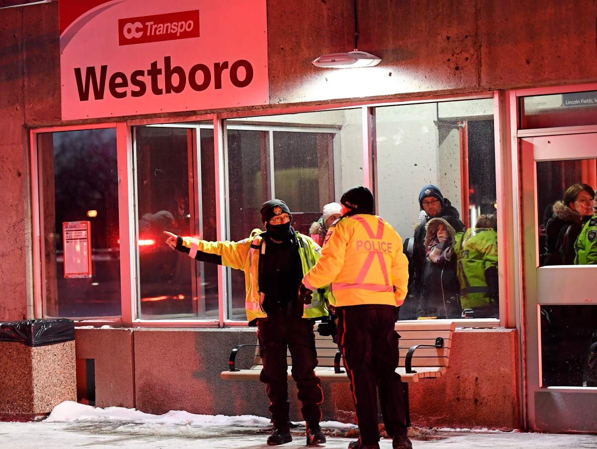 Police and first responders work at the scene where a double-decker city bus struck a transit shelter in Ottawa, on Friday, Jan. 11, 2019.
