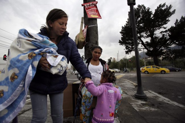 Venezuelan migrants beg for money in Quito, Ecuador, Nov. 22, 2018.