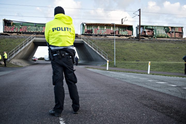 A policeman stands in front of a damaged freight train at the Great Belt Bridge, Denmark, 02 January 2019, after a train accident.