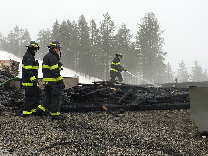 Firefighters investigate the ruins of the under-construction house that was destroyed by fire early Thursday.