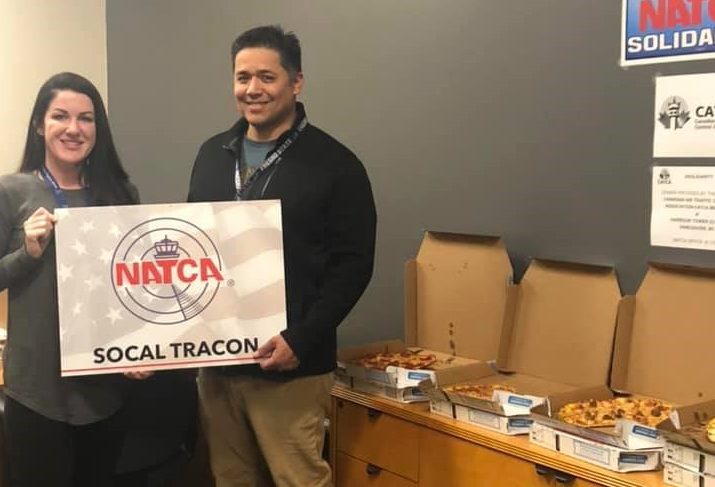 Employees show off their pizza haul in the US from Winnipeg.