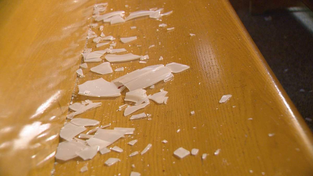 Broken glass spread across a pew at St. Peter’s Catholic Church.