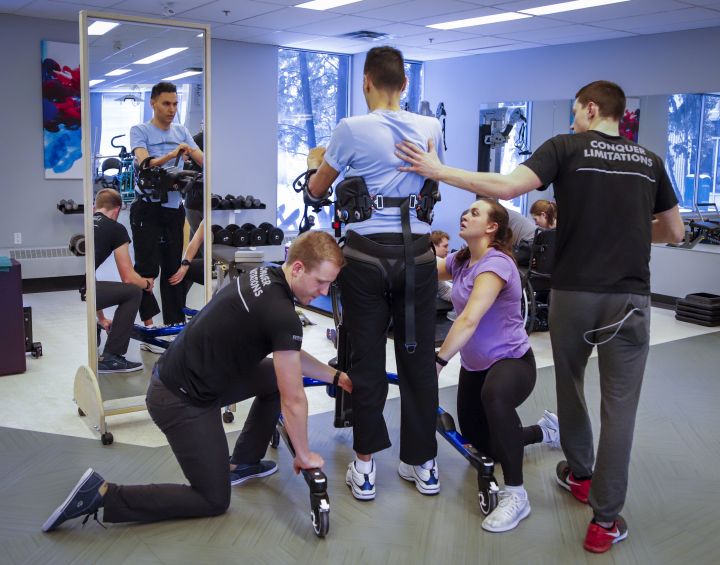 Dr. Richi Gill, in grey shirt, a Calgary doctor, takes part in physiotherapy in Calgary, Alta., Wednesday, Feb. 13,