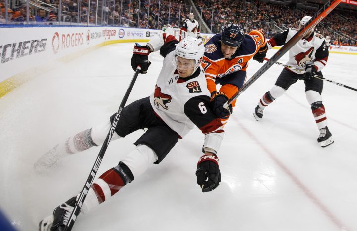 Arizona Coyotes’ Jakob Chychrun (6) and Edmonton Oilers’ Milan Lucic (27) battle for the puck during second period NHL action in Edmonton, Alta., on Tuesday, Feb. 19, 2019.