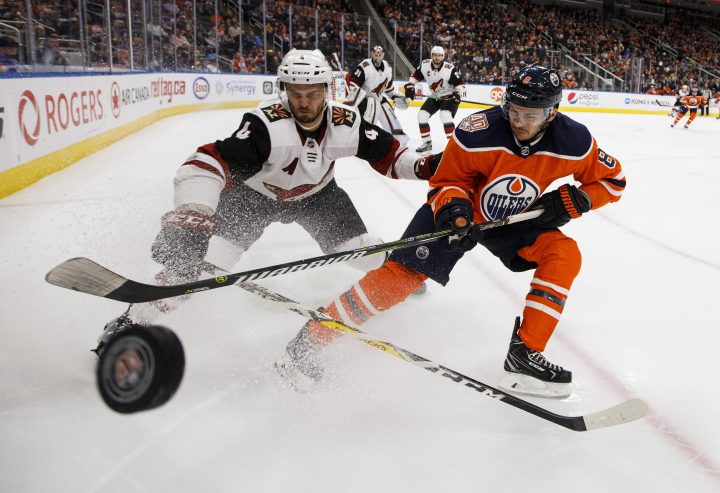 Arizona Coyotes’ Niklas Hjalmarsson (4) and Edmonton Oilers’ Ty Rattie (8) battle for the puck during second period NHL action in Edmonton, Alta., on Tuesday, Feb. 19, 2019.