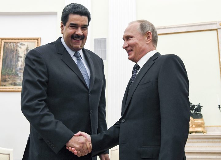 In this file pool photo taken on Oct. 4, 2017, Russian President Vladimir Putin, right, shakes hands with Venezuela’s President Nicolas Maduro during their meeting at the Kremlin in Moscow, Russia.