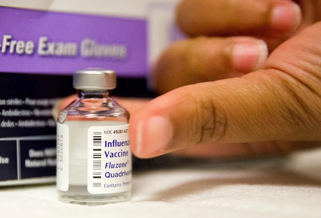 In this Wednesday, Feb. 7, 2018 file photo, a nurse prepares a flu shot from a vaccine vial at the Salvation Army in Atlanta.