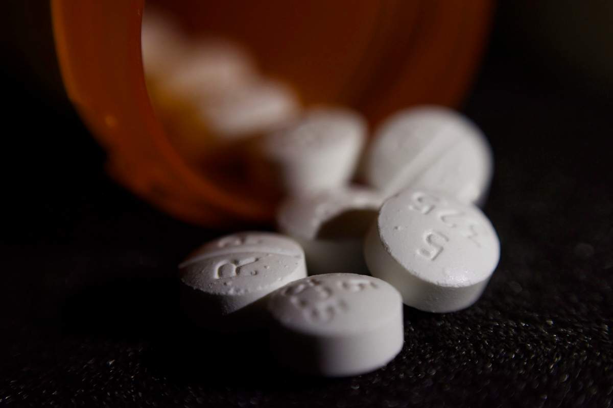 FILE - This Tuesday, Aug. 15, 2017 file photo shows an arrangement of pills of the opioid oxycodone-acetaminophen in New York. In an innovative experiment, doctors prescribed fewer opioids after learning of their patient's overdose death in a letter from a county medical examiner. More than 400 ÄúDear DoctorÄù letters, sent in 2017 in San Diego County, were part of a study that put a human face on the U.S. opioid crisis for many doctors. (AP Photo/Patrick Sison).