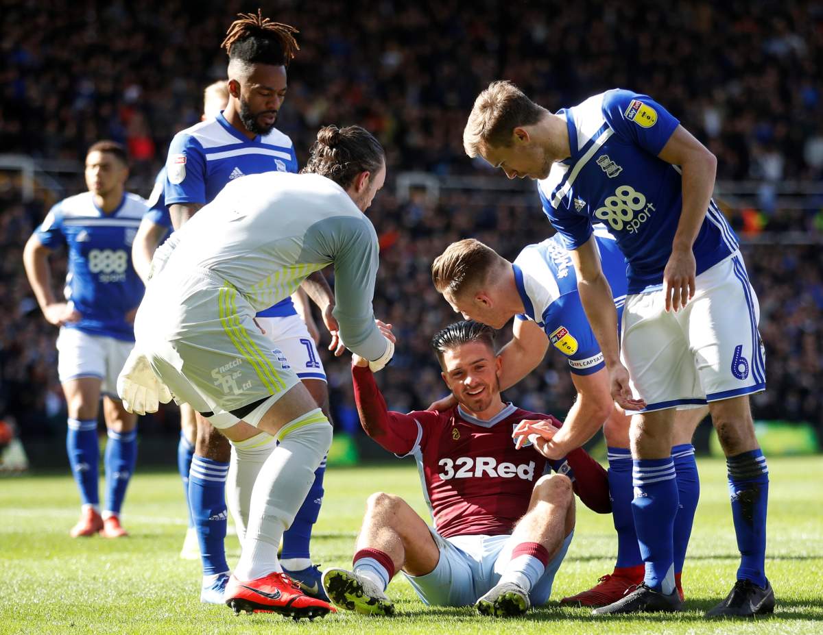 Aston Villa’s Jack Grealish sits on the floor after being attacked by a fan on March 10, 2019, while playing Birmingham City at St. Andrew’s Stadium.