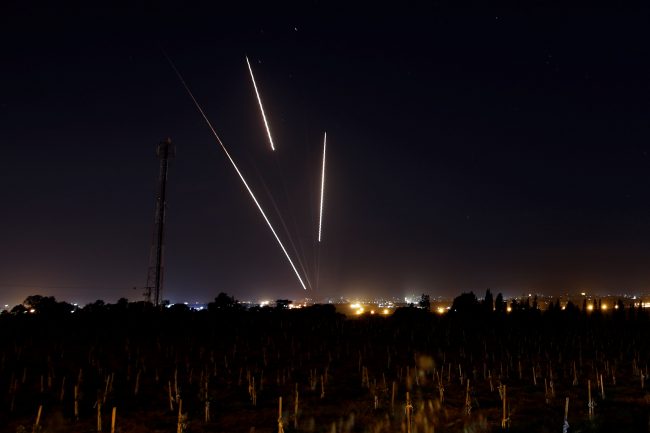 Streaks of light are pictured as rockets are launched from the Gaza Strip towards Israel, March 25, 2019.