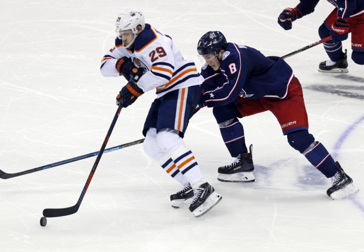 Edmonton Oilers forward Leon Draisaitl, left, of Germany, controls the puck against Columbus Blue Jackets defenseman Zach Werenski during the third period of an NHL hockey game in Columbus, Ohio, on Saturday, March 2, 2019. The Oilers won 4-0.