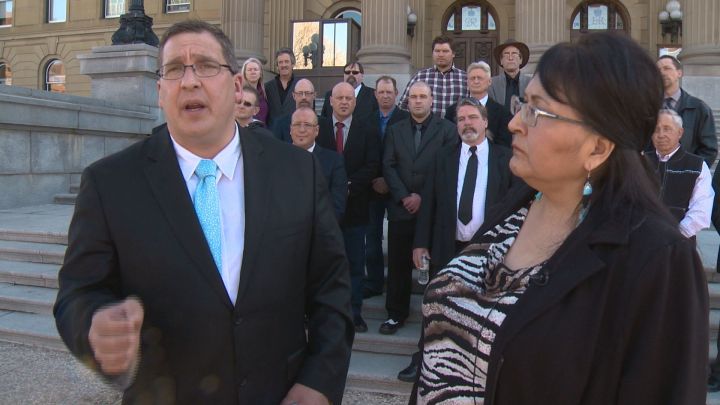 Dave Bjorkman (front left), Virginia Bruneau (front right) and other members of the Alberta Independence Party are pictured at a media event outside the Alberta legislature on March 20, 2019.