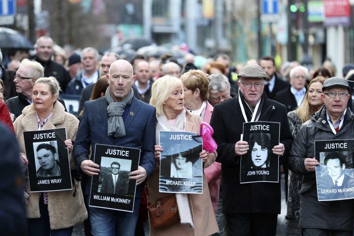 Families hold photographs of the victims of Bloody Sunday and march through the Bogside in Londonderry, Northern Ireland, Thursday March 14, 2019.