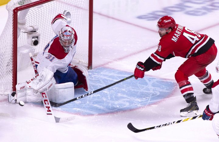 Montreal Canadiens goaltender Carey Price stops Carolina Hurricanes' Jordan Martinook during second period NHL hockey action in Montreal on Thursday, December 13, 2018. 