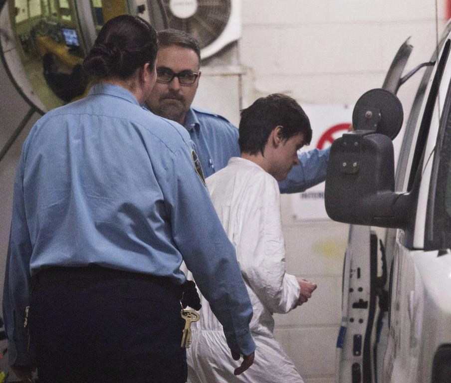 Alexandre Bissonnette is escorted to a van after appearing in court for the deadly shooting at a mosque, Monday, January 30, 2017 in Quebec City. 