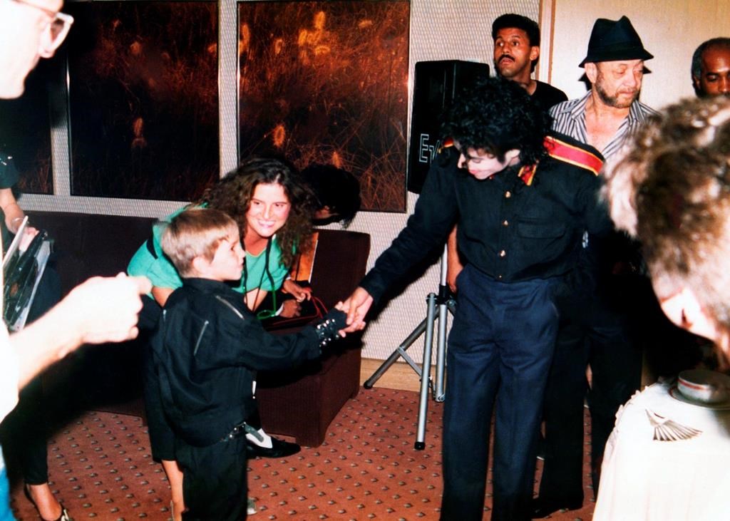 A young Wade Robson shaking hands with pop icon Michael Jackson in 1987 in a scene from HBO’s documentary, ‘Leaving Neverland.’