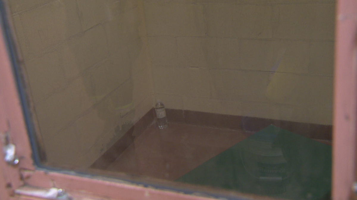A view of one of the IPDA cells peering in through the lone window on the door.