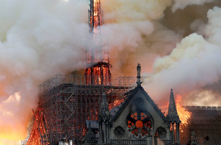 Smoke billows as fire engulfs the spire of Notre Dame Cathedral in Paris.