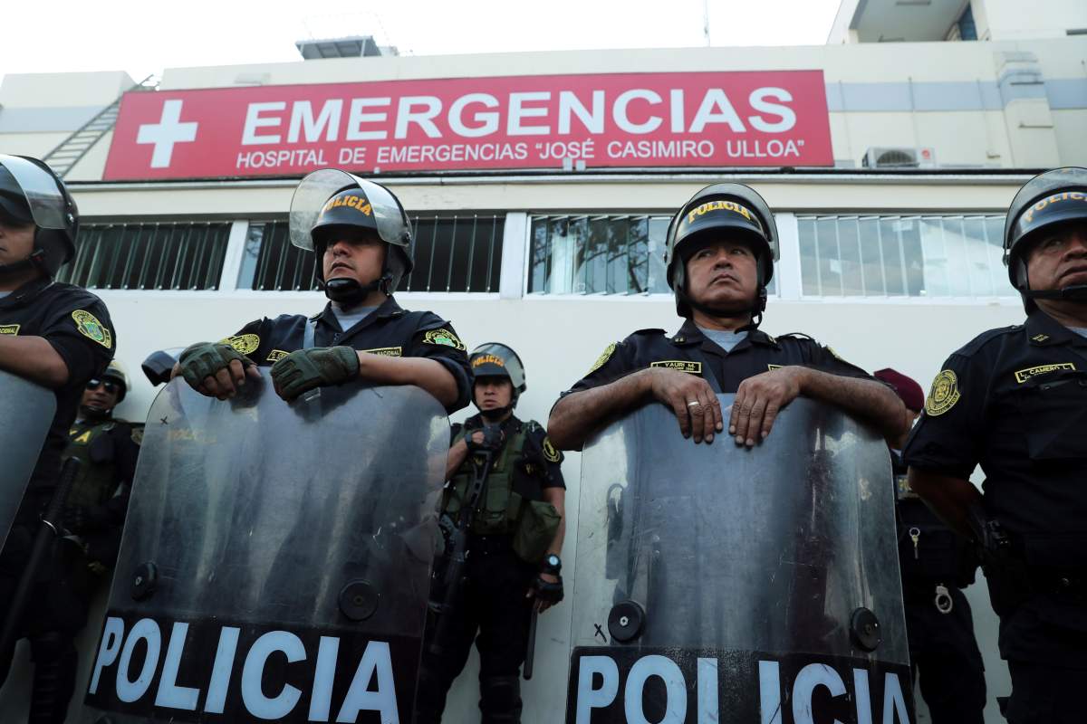 Police stand guard outside a hospital where Peru’s former President Alan Garcia was taken after he shot himself, in Lima, Peru, on April 17, 2019.