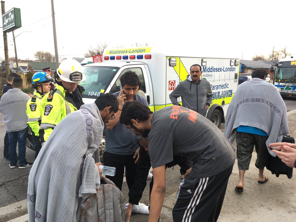 A group of young men who live in one of the building’s three units say they jumped through a window to escape the flames.