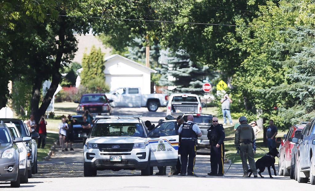 The RCMP emergency response unit arrests an alleged suspect in Neepawa, Man., on August 30, 2018, following the shooting of a RCMP officer in Onanole, Man. A Manitoba man who shot at two RCMP officers and left one with severe injuries has been given an 18-year prison sentence. Therae Racette-Beaulieu was sentenced after pleading guilty earlier this year to charges of attempted murder, break and enter, and robbery in connection with a string of crimes in western Manitoba last summer. THE CANADIAN PRESS/John Woods.