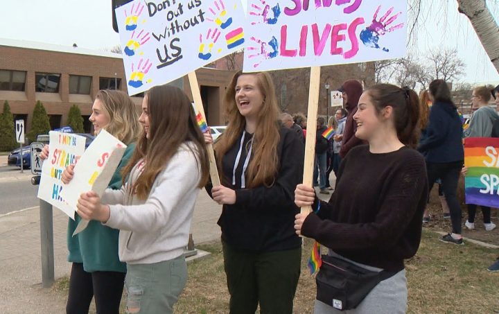 Chazley Kesler (right) was one of more than 100 people who rallied in Lethbridge on Tuesday to support gay-straight alliances.