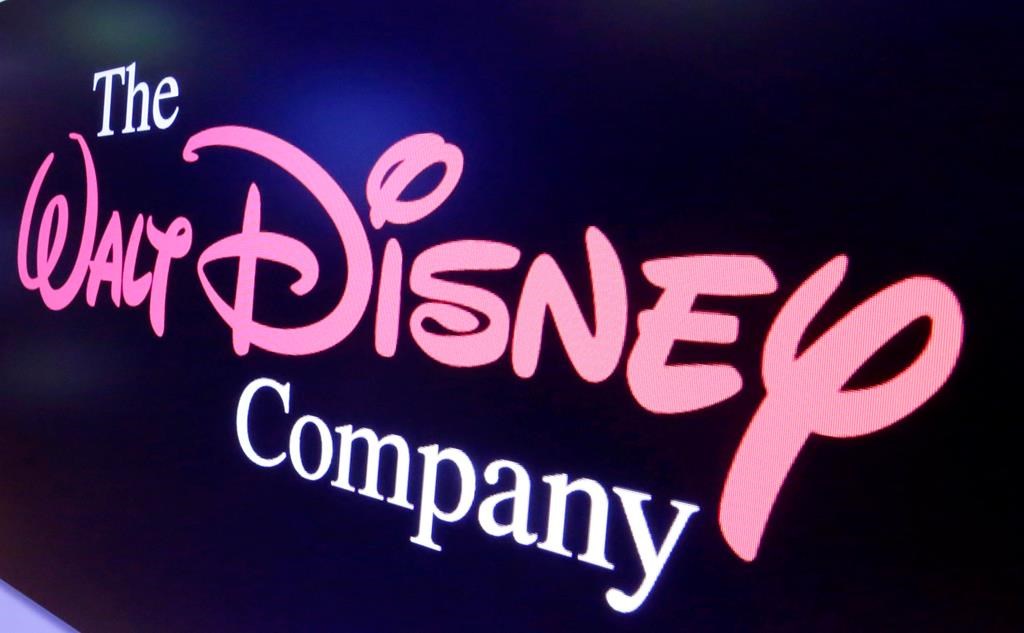 FILE - In this Aug. 7, 2017, file photo, The Walt Disney Co. logo appears on a screen above the floor of the New York Stock Exchange.