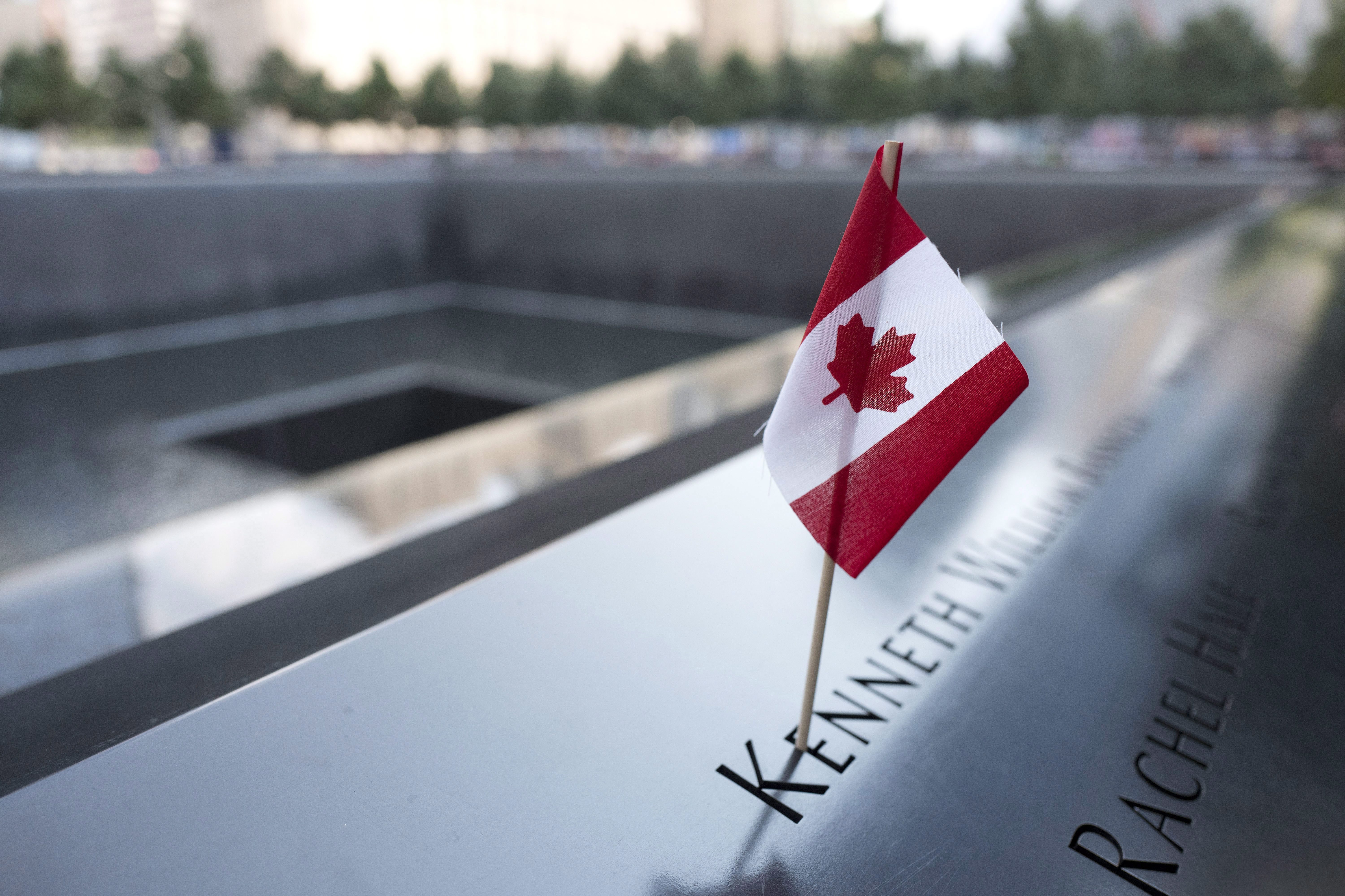A Canadian flag is placed at the name of Kenneth William Basnicki at the North Pool of the National Sept. 11 Memorial, Tuesday, Sept. 5, 2017, in New York.