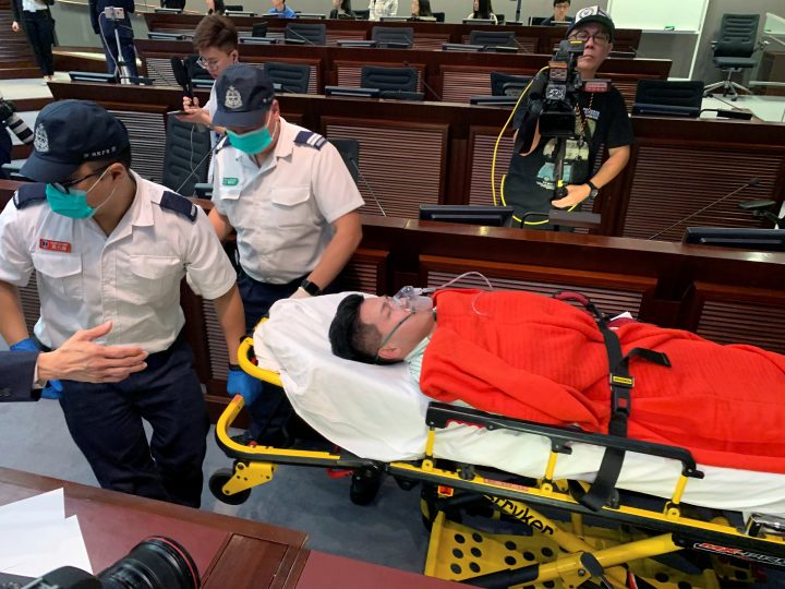 Pro-democracy lawmaker Gary Fan is carried away on a stretcher after clashes with pro-Beijing lawmakers during a meeting for control of a meeting room to consider the controversial extradition bill, in Hong Kong, China May 11, 2019.