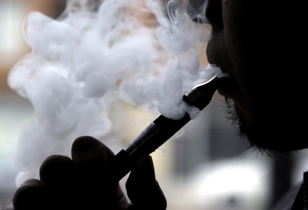A man smokes an electronic cigarette in Chicago on April 23, 2014. THE CANADIAN PRESS/AP/Nam Y. Huh, File.