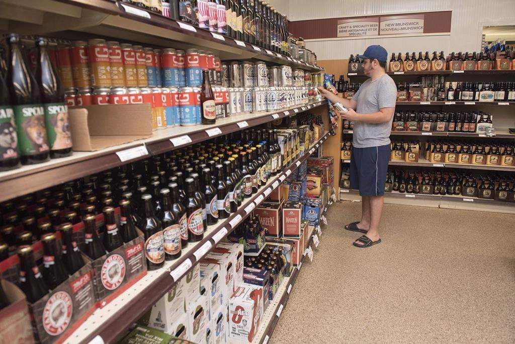 A customer shops in the craft beer section of the NB Liquor store in Fredericton, N.B., on Friday, June 16, 2017.