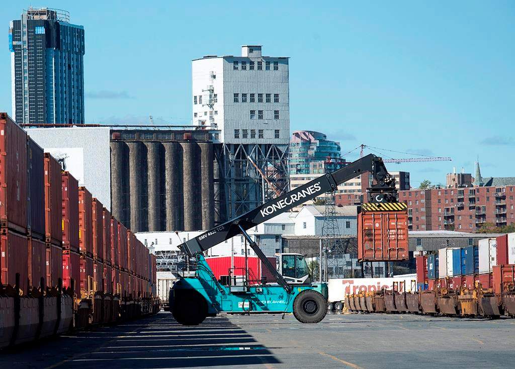 Shipping containers are moved at the Halterm Container Terminal in Halifax on Friday, Oct. 19, 2018.