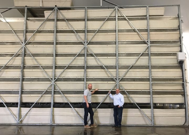 Keith Driver and Tom Grande stand in front of the tanks at the shrimp farm near Strathmore, Alta., on May 1, 2019.