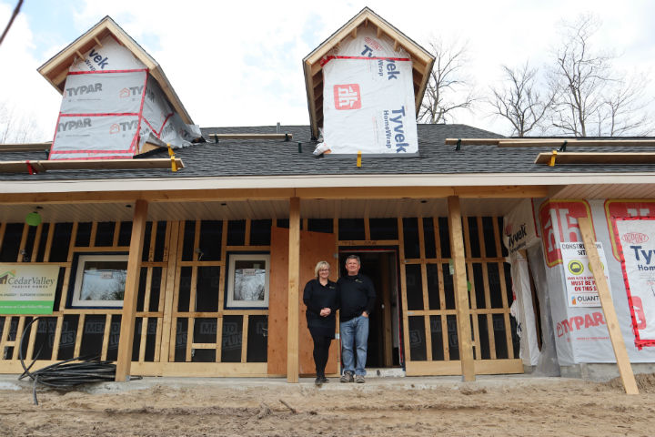 Koko and Robert Saar stand in front of their Wasaga Beach passive house, which is expected to complete construction in the summer.