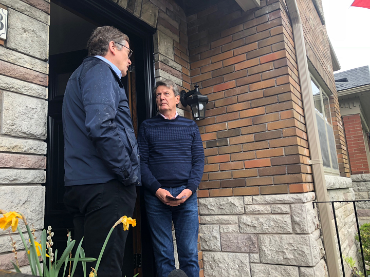 Mayor Tory speaking to a resident about provincial budget cuts on Saturday.