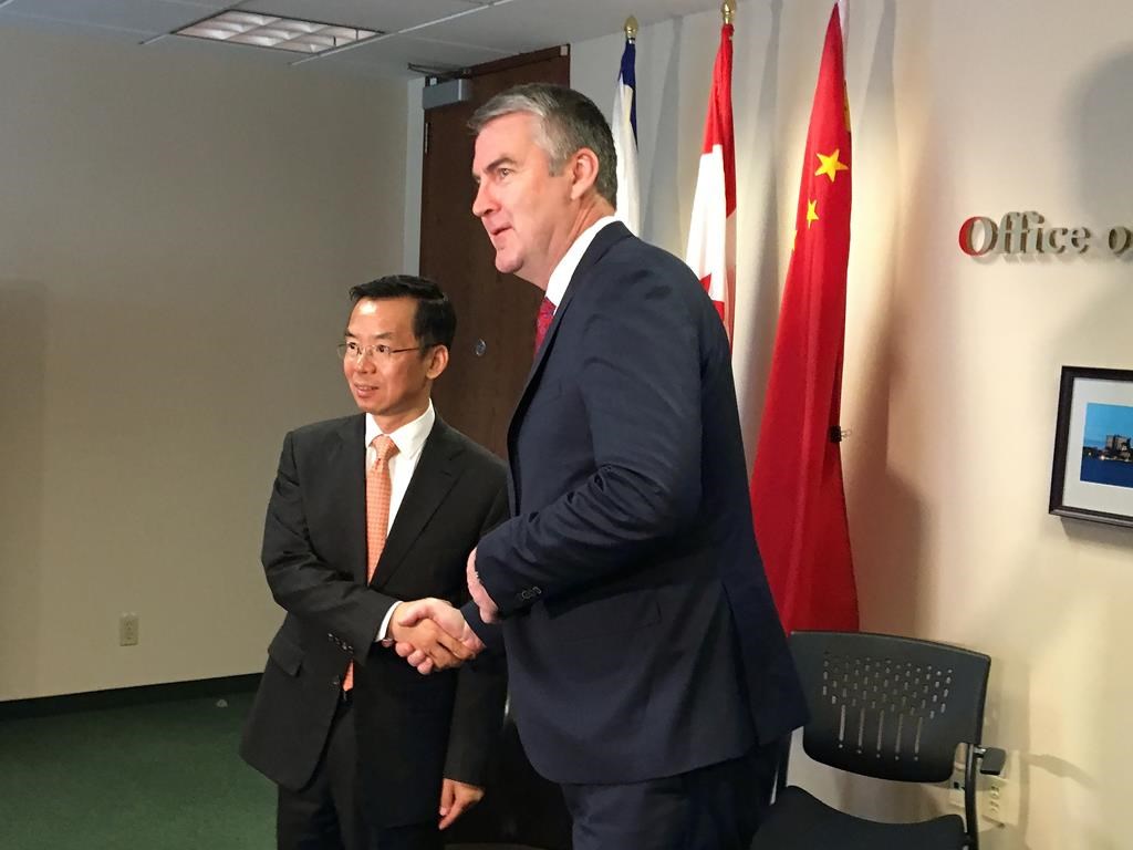 China's ambassador to Canada Lu Shaye shakes hands with Nova Scotia Premier Stephen McNeil in Halifax on Wednesday, May 29, 2019.