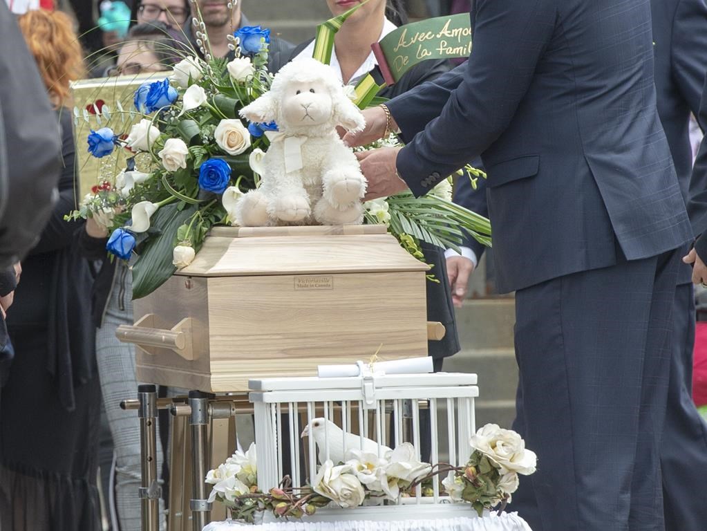 The casket of a seven-year-old girl who was found in critical condition inside of a home is carried from the church after funeral services, Thursday, May 9, 2019 in Granby, Que.