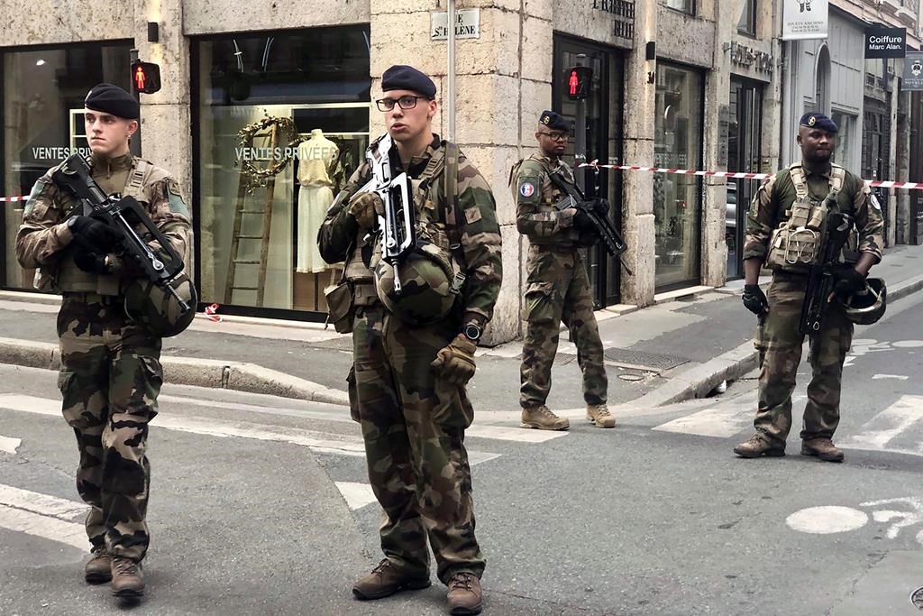 Soldiers of French antiterrorist plan “Vigipirate Mission”, secure the access near the site of a suspected bomb attack in central Lyon, Friday May, 24, 2019.