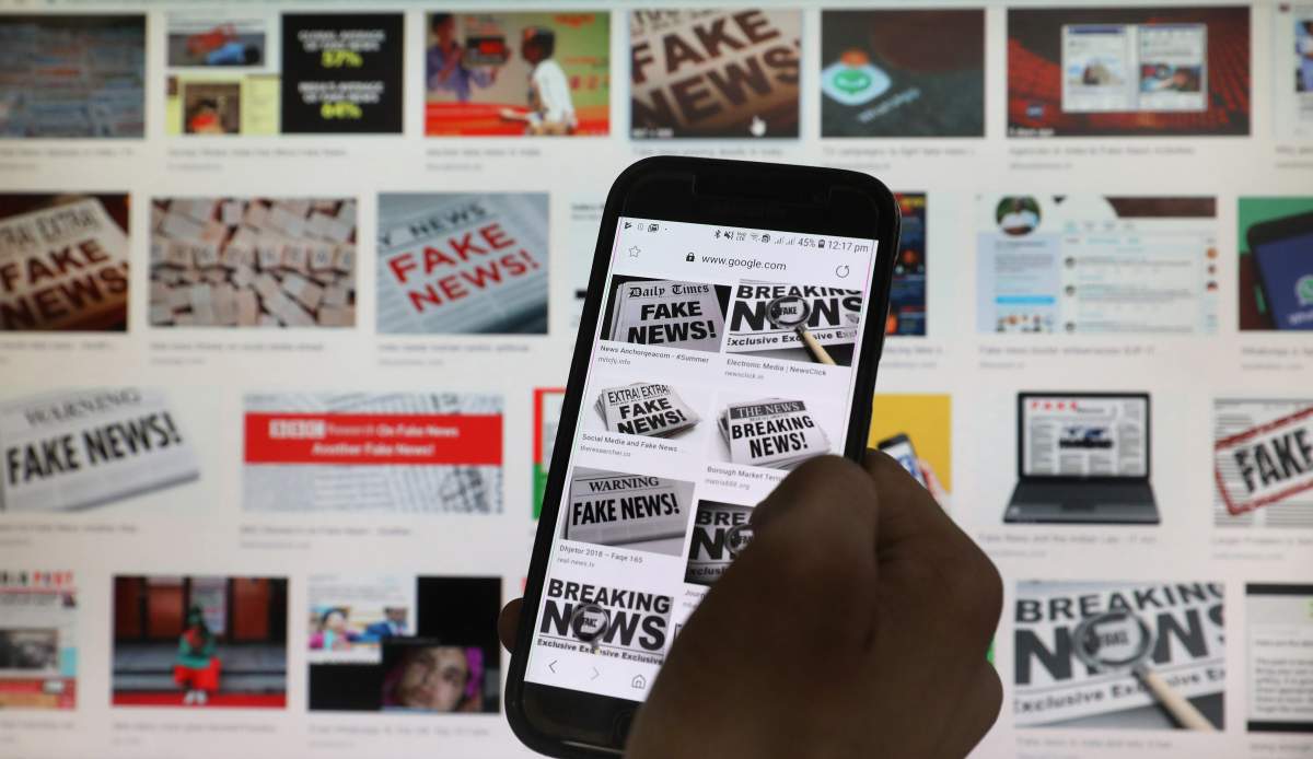 A person scrolls the screen of a mobile phone while loading information on how to counter fake news in New Delhi, India, in May 2019.
